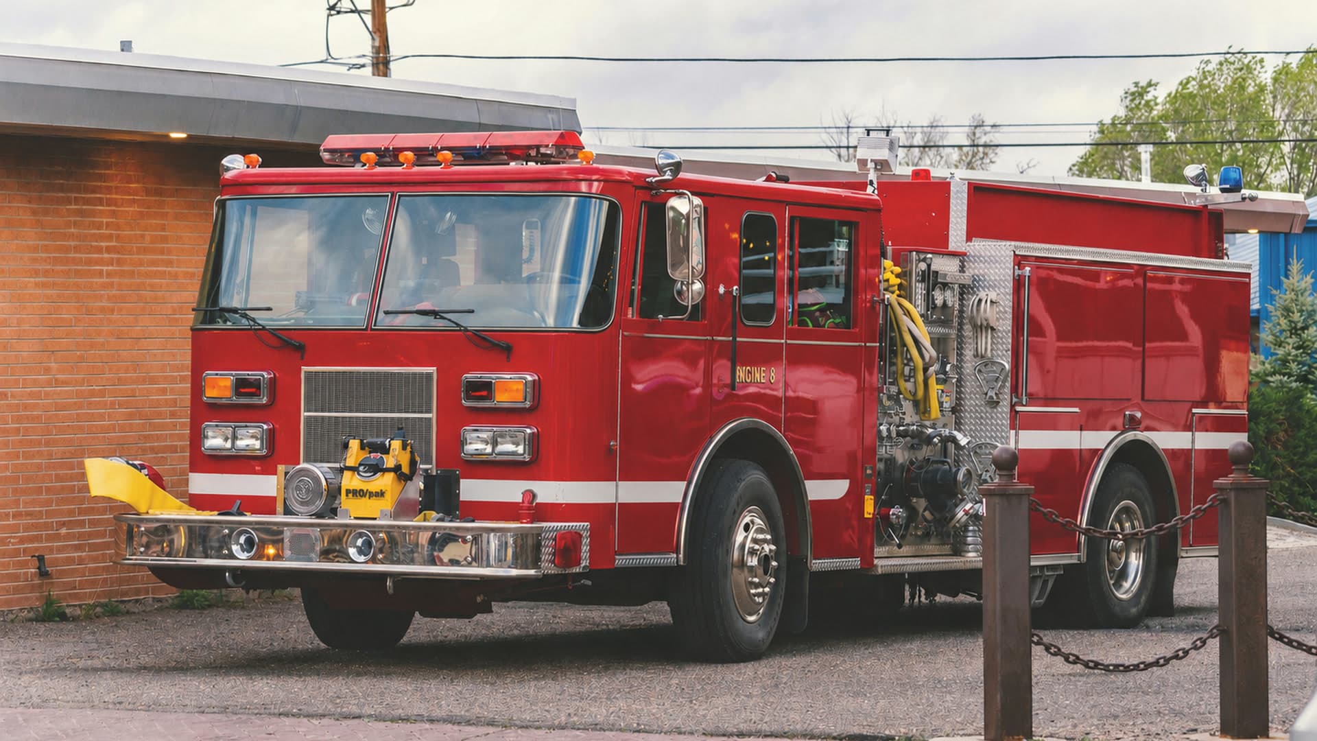 Red fire apparatus parked outside a fire station